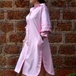 Model in Pink Relaxed buttoned down dress posing side