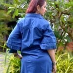 Model in Navy Relaxed buttoned down dress posing back