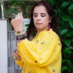 Model in YellowEmbroidered Beetles Top posing front