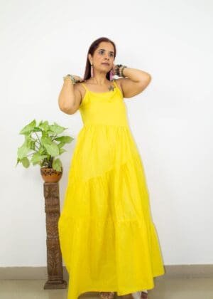 Model in Yellow Low-back tiered Dress posing front