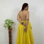 Model in Yellow Low-back tiered Dress posing back