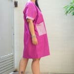 Model in Pink Two Toned Pocket Dress posing side